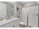 Bathroom featuring glass shower with white tiles and a white vanity with grey countertop at 2028 Woodleaf Hammock Ct, Bradenton, FL 34211