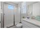 Bathroom with glass shower and white vanity, and a small window for natural light at 2028 Woodleaf Hammock Ct, Bradenton, FL 34211