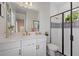 Elegant bathroom with white vanity, modern fixtures, and a stylish shower with decorative tile at 2028 Woodleaf Hammock Ct, Bradenton, FL 34211
