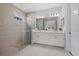 Modern bathroom features a glass shower, double vanity, and sleek tile design at 2028 Woodleaf Hammock Ct, Bradenton, FL 34211