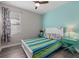 Bedroom with beachy theme, light teal walls, wood floors and lots of natural light at 2028 Woodleaf Hammock Ct, Bradenton, FL 34211