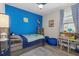 Bright bedroom features a blue accent wall, neutral furniture, and a comfortable layout at 2028 Woodleaf Hammock Ct, Bradenton, FL 34211