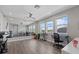 Large bonus room featuring exercise equipment, mirrors, and beautiful windows with backyard view at 2028 Woodleaf Hammock Ct, Bradenton, FL 34211