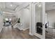 Hallway leading to a well-decorated living area with modern decor and staircase, office space is visible to the right at 2028 Woodleaf Hammock Ct, Bradenton, FL 34211