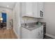A convenient kitchenette features white cabinets, counter space, and modern appliances at 2028 Woodleaf Hammock Ct, Bradenton, FL 34211