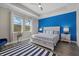 A beautifully decorated primary bedroom featuring a tray ceiling, neutral walls, and a large window at 2028 Woodleaf Hammock Ct, Bradenton, FL 34211