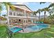 Inviting backyard featuring a sparkling pool, patio seating, and a putting green at 203 72Nd St, Holmes Beach, FL 34217