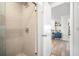 Modern bathroom with glass-enclosed shower and elegant fixtures, leading to additional space at 203 72Nd St, Holmes Beach, FL 34217