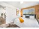 Stylish bedroom featuring wood paneling accent, large windows and modern decor at 203 72Nd St, Holmes Beach, FL 34217