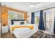 Bright bedroom featuring wood paneling, large windows, and access to a balcony at 203 72Nd St, Holmes Beach, FL 34217