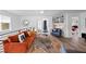Stylish living room featuring an orange sofa, unique rug, and an inviting, open layout at 203 72Nd St, Holmes Beach, FL 34217