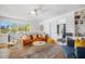 Open living area with an orange couch, stylish rug, and access to additional rooms at 203 72Nd St, Holmes Beach, FL 34217