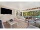 Spacious covered patio with a lounge area, dining table and a TV for entertaining at 203 72Nd St, Holmes Beach, FL 34217
