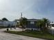 Charming single-story home featuring a screened-in porch, brick patio and well-manicured lawn at 2601 Gulf N Dr # S2, Bradenton Beach, FL 34217