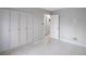 View of a bedroom featuring tile floors, a closet, and view into an ensuite at 4717 Winslow Beacon # 7, Sarasota, FL 34235