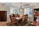 Traditional dining room features a wooden table, upholstered chairs, and ample natural light at 6310 Watercrest Way # 201, Lakewood Ranch, FL 34202