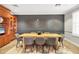 Staged dining room with wood table, grey chairs, and decorative wall art, complemented by built-in shelving and a modern rug at 6310 Watercrest Way # 201, Lakewood Ranch, FL 34202