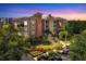 Beautiful multi-story condo building featuring manicured landscaping and colorful sunset skies at 6310 Watercrest Way # 201, Lakewood Ranch, FL 34202