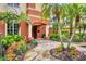 Beautifully landscaped entrance with tropical plants leading to a welcoming doorway at 6310 Watercrest Way # 201, Lakewood Ranch, FL 34202