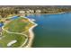 Aerial view of a golf course next to a body of water in a serene community, showcasing a peaceful and recreational setting at 6310 Watercrest Way # 201, Lakewood Ranch, FL 34202