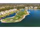 Scenic aerial view of a golf course surrounded by water, highlighting the harmonious blend of recreation and natural beauty at 6310 Watercrest Way # 201, Lakewood Ranch, FL 34202