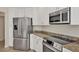 Kitchen showcasing stainless steel appliances, granite countertops, and white cabinetry at 6310 Watercrest Way # 201, Lakewood Ranch, FL 34202
