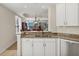 Bright kitchen featuring granite countertops, and white cabinetry with an eat-in space at 6310 Watercrest Way # 201, Lakewood Ranch, FL 34202