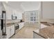 Well-lit kitchen featuring a stainless steel oven, microwave and a large bay window overlooking the yard at 6310 Watercrest Way # 201, Lakewood Ranch, FL 34202