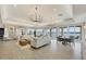 Spacious living room features lots of seating, stylish chandeliers, and balcony access with serene water views at 6310 Watercrest Way # 201, Lakewood Ranch, FL 34202