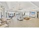 Bright living room boasts multiple seating areas, elegant chandeliers and sliding glass doors overlooking the waterfront at 6310 Watercrest Way # 201, Lakewood Ranch, FL 34202