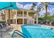 Relax by the pool with a lovely clubhouse view surrounded by lush landscaping at 6310 Watercrest Way # 201, Lakewood Ranch, FL 34202