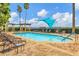 Inviting community pool area featuring comfortable lounge chairs, sunshades, and palm trees for a relaxing outdoor experience at 6310 Watercrest Way # 201, Lakewood Ranch, FL 34202