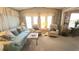 Warm living room featuring bright natural lighting, a cozy sofa, and armchairs at 3333 26Th E Ave # 1219, Bradenton, FL 34208