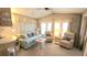 Comfortable living room featuring bright natural lighting, a cozy sofa, and two armchairs at 3333 26Th E Ave # 1219, Bradenton, FL 34208