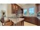 Wet bar area with granite countertops, display cabinets, a wine fridge, and a view of the outdoor area at 3625 Casey Key Rd, Nokomis, FL 34275