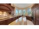 Gourmet kitchen featuring custom cabinetry, granite countertops, and a center island with breakfast bar at 3625 Casey Key Rd, Nokomis, FL 34275
