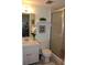 Cozy bathroom featuring a single sink vanity and a glass-enclosed shower at 3682 Lake Bayshore Dr # K402, Bradenton, FL 34205