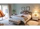 Serene bedroom with soft lighting, a plush bed, and access to a private balcony at 3682 Lake Bayshore Dr # K402, Bradenton, FL 34205