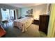 Light bedroom featuring a cozy bed, balcony access and soft lighting at 3682 Lake Bayshore Dr # K402, Bradenton, FL 34205
