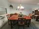 Traditional dining room with a large wood table, chandelier, and classic furnishings at 3682 Lake Bayshore Dr # K402, Bradenton, FL 34205