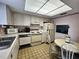 Functional eat-in kitchen features white appliances and tiled flooring at 3682 Lake Bayshore Dr # K402, Bradenton, FL 34205