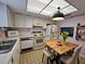 Cozy eat-in kitchen features white appliances, ample cabinet space, and a bright, airy ceiling at 3682 Lake Bayshore Dr # K402, Bradenton, FL 34205