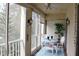 Enclosed lanai with a small table, chairs, and a leafy potted plant at 3682 Lake Bayshore Dr # K402, Bradenton, FL 34205