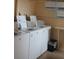 Laundry room with multiple washers and posters on the wall about laundry room hours at 3682 Lake Bayshore Dr # K402, Bradenton, FL 34205