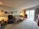 Relaxing living room features comfortable seating, a coffee table, and access to the outdoor balcony at 3682 Lake Bayshore Dr # K402, Bradenton, FL 34205