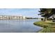 Beautiful waterfront view showcasing the serene lake and lush landscaping around the condominium building at 3682 Lake Bayshore Dr # K402, Bradenton, FL 34205