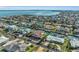 Wide aerial view of a waterfront community with canals, swimming pools, and well-manicured lawns at 550 Yardarm Ln, Longboat Key, FL 34228