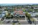 Aerial view of waterfront home showing red tile roof, lush landscaping, pool, and canal access at 550 Yardarm Ln, Longboat Key, FL 34228