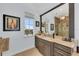 Well-lit bathroom featuring a large vanity with a decorative mirror and a window with a picturesque view at 550 Yardarm Ln, Longboat Key, FL 34228