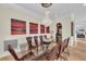 Dining room with a glass table and leather chairs, complemented by modern artwork and a chandelier at 550 Yardarm Ln, Longboat Key, FL 34228